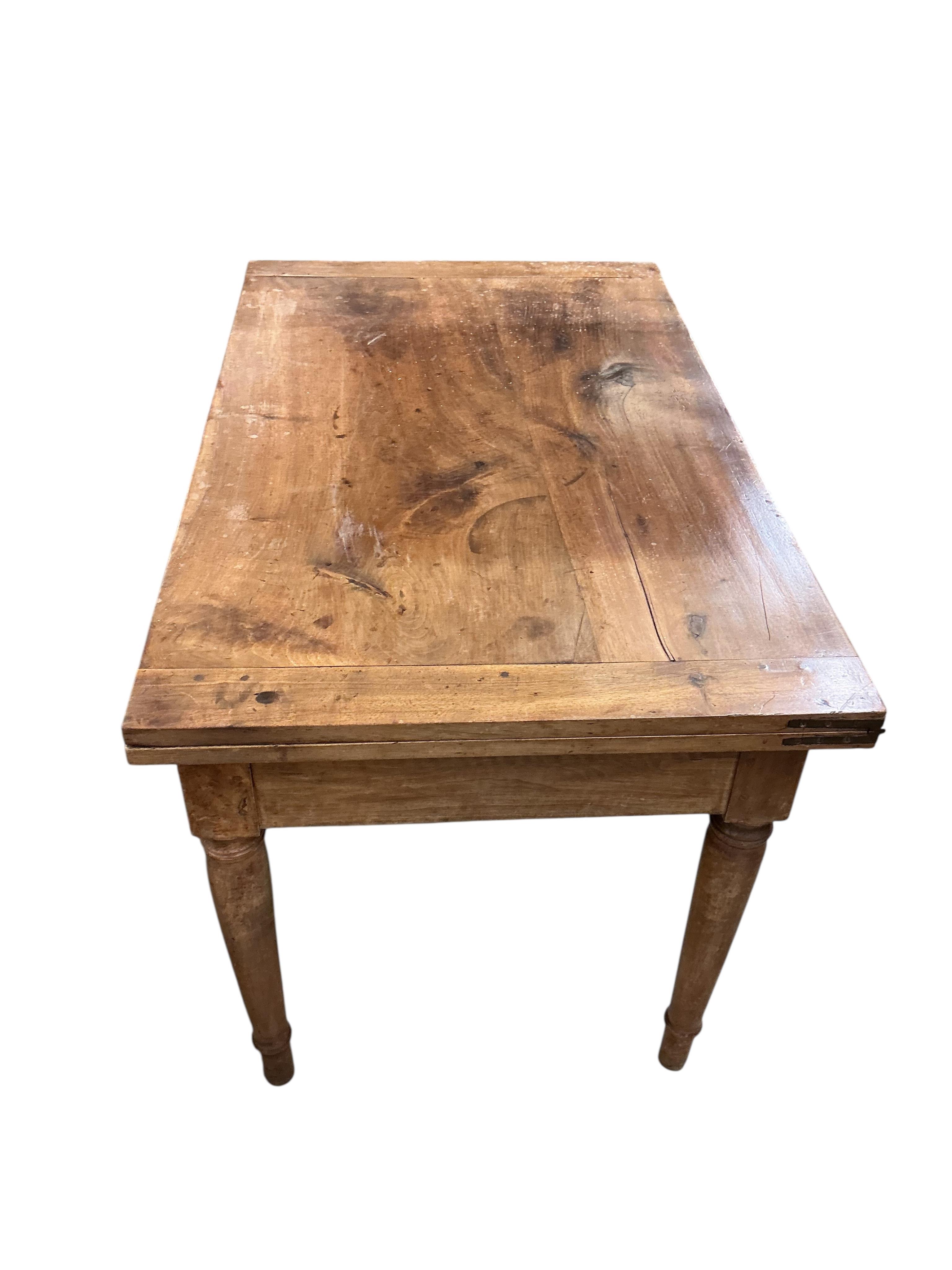 A 19th century French folding fruitwood kitchen table, width 117cm, depth 72cm, height 74cm